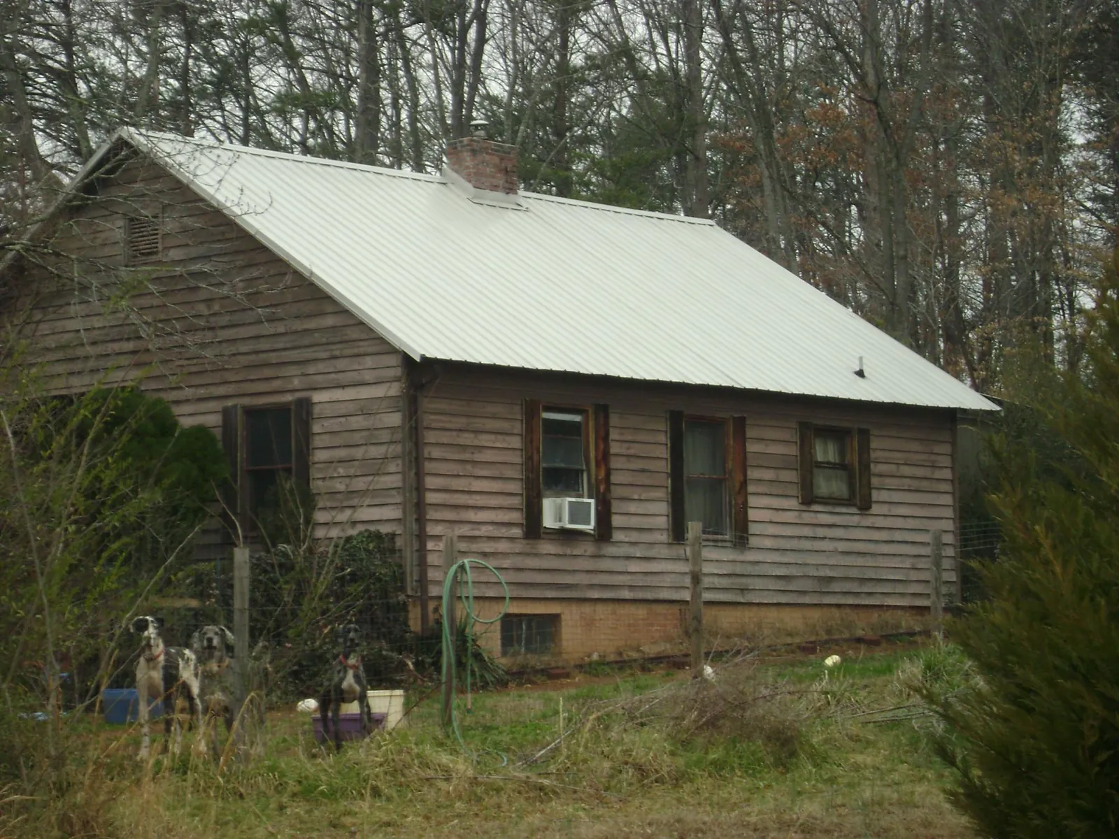 White metal roof on an old wood sided farmhouse, from a Metal Roof Installation job in Glenarm